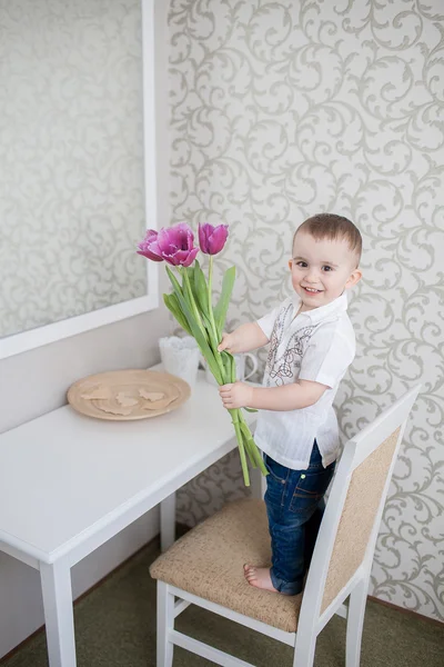 Cute baby boy with tulip — Stock Photo, Image