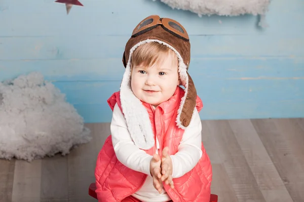 Little girl sitting in wooden toy plane — Stock Photo, Image