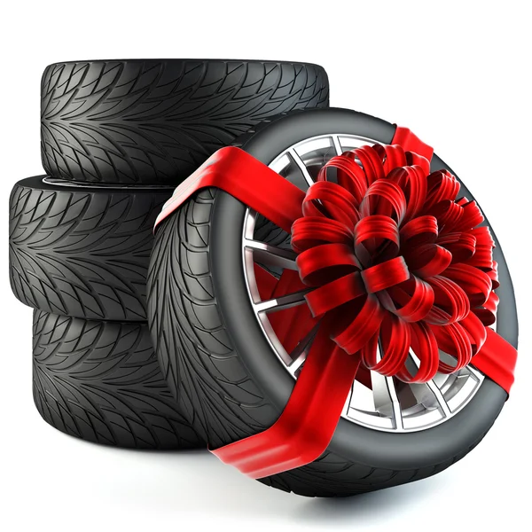 Tires wrapped in red gift ribbon with bow — Stock Photo © dimdimich