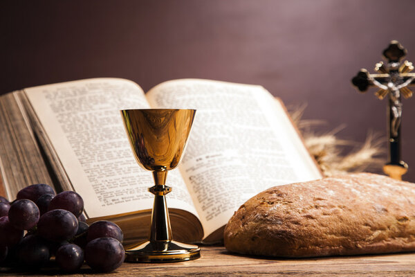 Sacred objects, bible, bread and wine.
