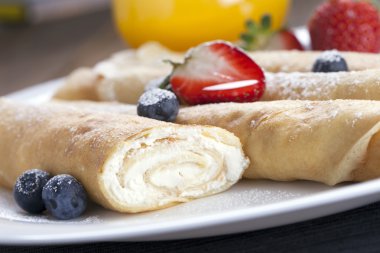 Lezzetli tatlı krep bir tabak taze meyve ile haddelenmiş