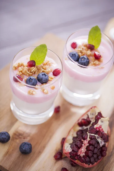 Delicious dessert, flakes flooded in two flavors yogurt with blu