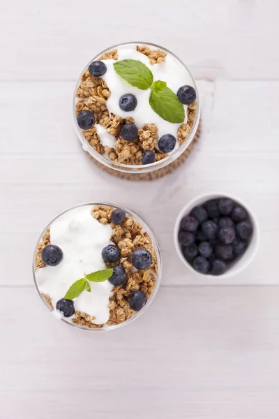 Delicious dessert, flakes flooded in two flavors yogurt with blu — Stock Photo, Image