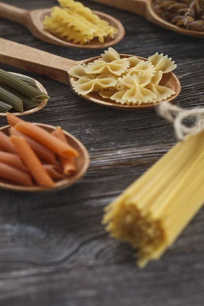A set of raw pasta on a wooden table — Stock Photo, Image
