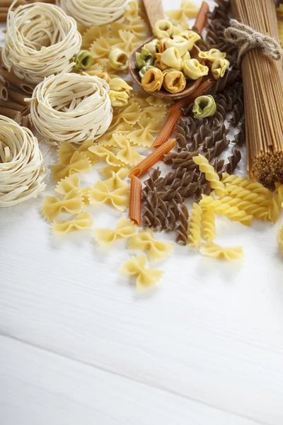 A set of raw pasta on a wooden table — Stock Photo, Image