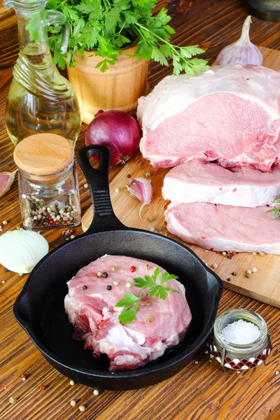 Raw pork steak in a frying pan — Stock Photo, Image