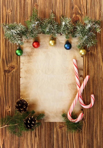 Kerstversiering op de oude vel papier op een houten rug — Stockfoto