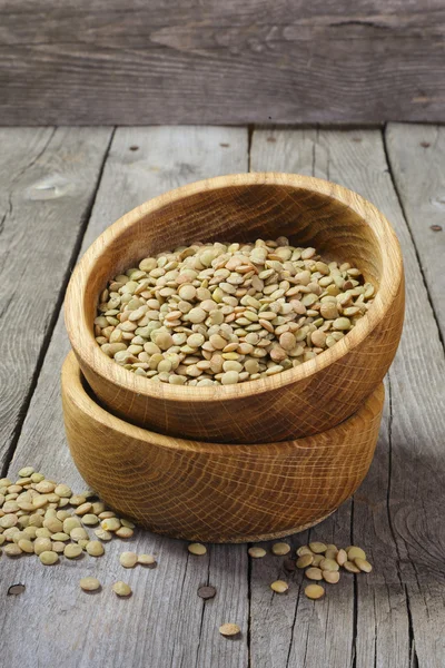 Dry lentils in a wooden bowl — Stock Photo, Image