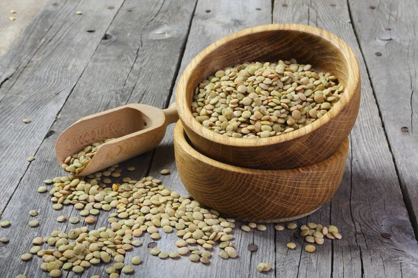 Dry lentils in a wooden bowl — Stock Photo, Image