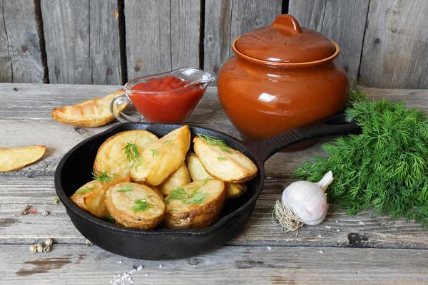 Baked potatoes with dill in village in a cast iron frying pan — Stock Photo, Image