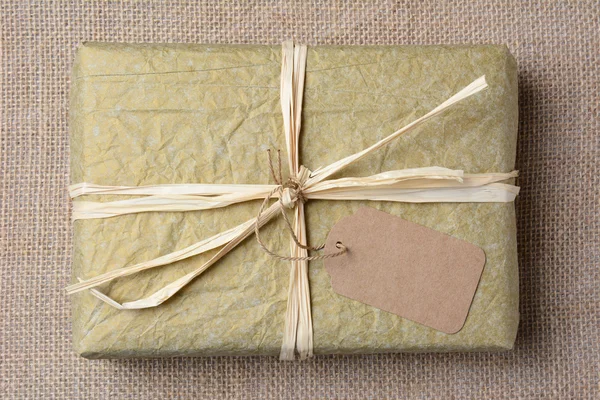 Gold Tissue Wrapped Gift — Stock Photo, Image