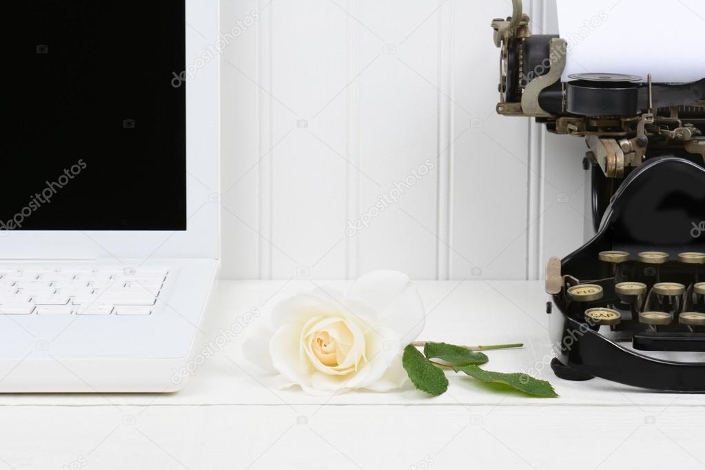 Rose on Desk Between Laptop and Typewriter