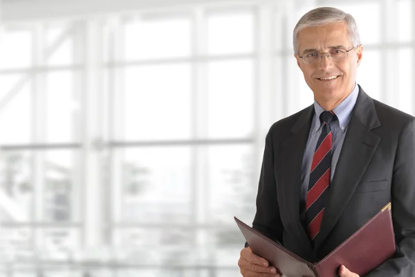 Mature Businessman Holding Folder — Stock Photo, Image