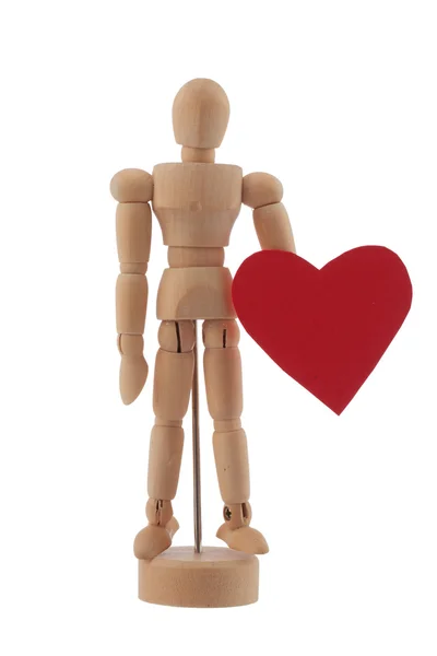 Estatua de juguete hombre de madera sostiene estudio corazón rojo aislado — Foto de Stock