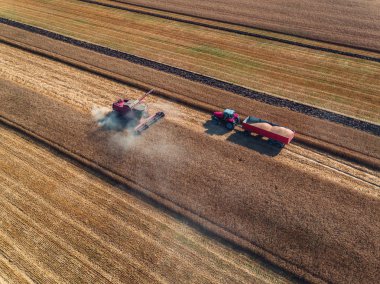 Aerial view of combine on harvest field clipart