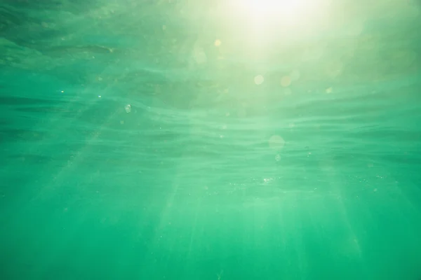 Подводный кадр с солнечными лучами и пузырьками в глубоком тропическом море — стоковое фото