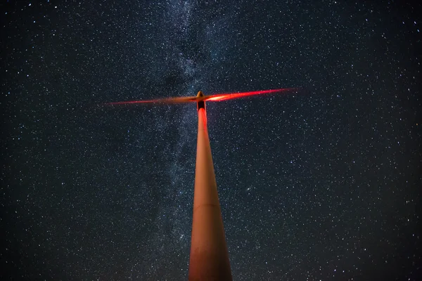 Wind turbines on the starry night sky with milkyway — Stock Photo, Image