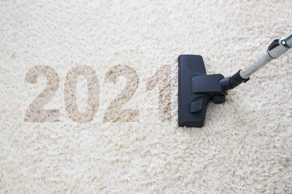 Home cleaning with vacuum cleaner and copy space for a text, new year 2021