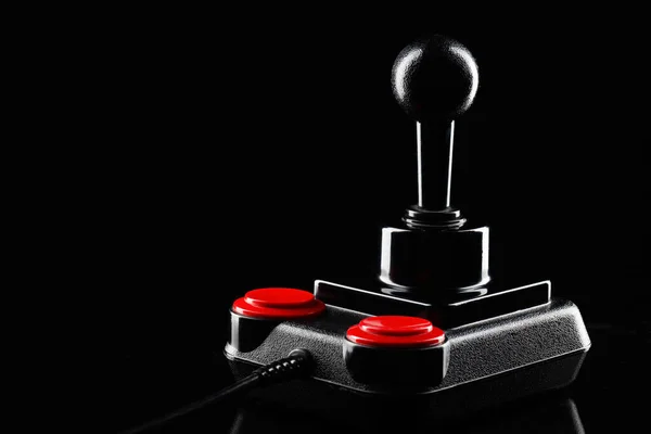 Retro joystick from 8-bit consoles. Game controller isolated on black background