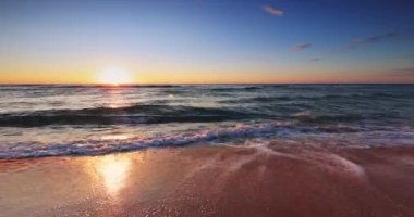 Okyanus dalgaları ve egzotik tropikal plajlar üzerinde gün doğumunda dramatik bulutlar