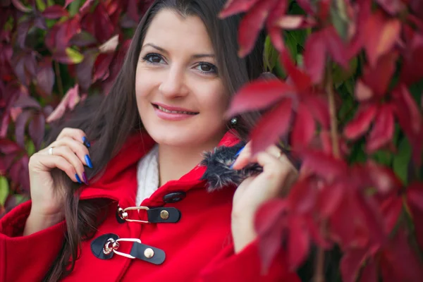 Beautiful girl in a red coat — Stock Photo, Image