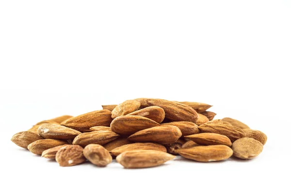 Almonds in heap over white — Stock Photo, Image