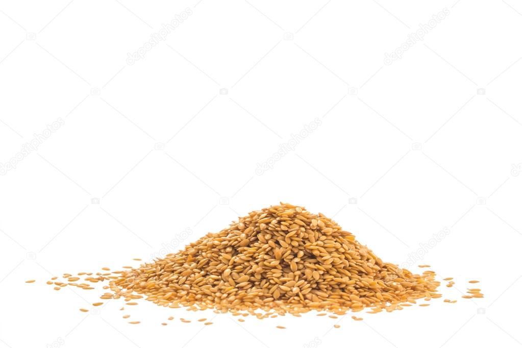 Pile of golden flax seed or linseed isolated on white background