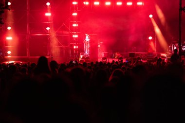 Sahne ışıkları ve insanlar bir müzik konserinde arka planlarını bozmak için kalabalıklar.