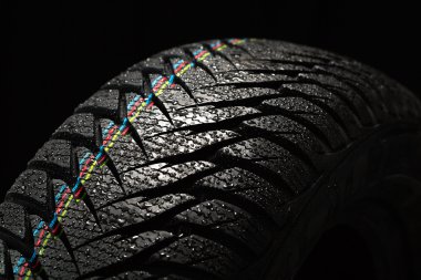Wet car tire on black