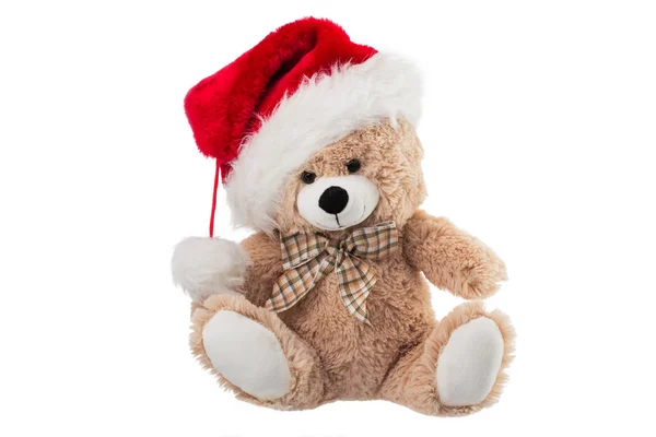 Flauschiger Teddybär mit Weihnachtsmütze isoliert auf weiß Stockfoto