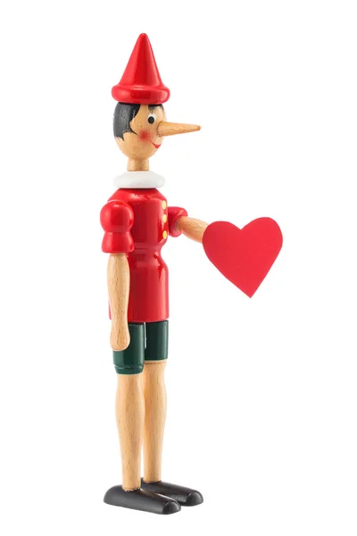 Pinocchio toy statue with heart isolated on white — Stock Photo, Image