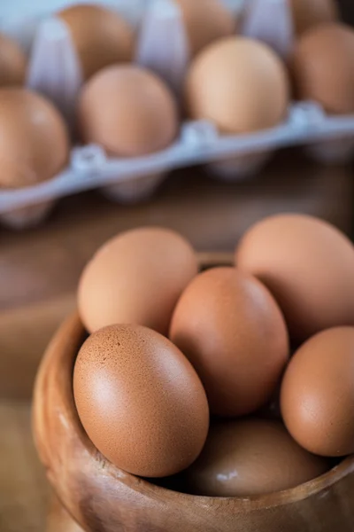 Frische Eier auf Holzteller — Stockfoto