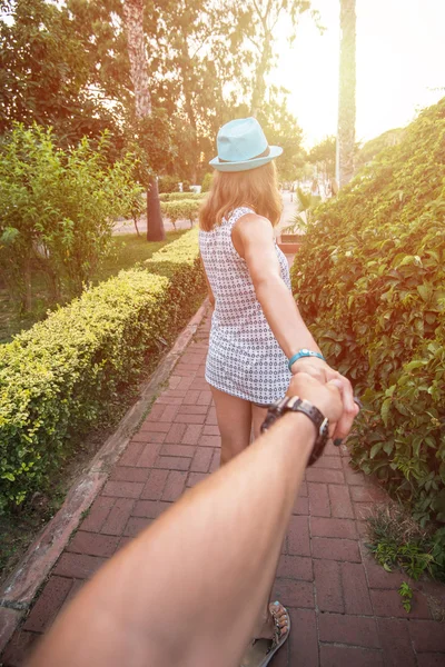 Girl holding a hand man on the street — Stock Photo, Image