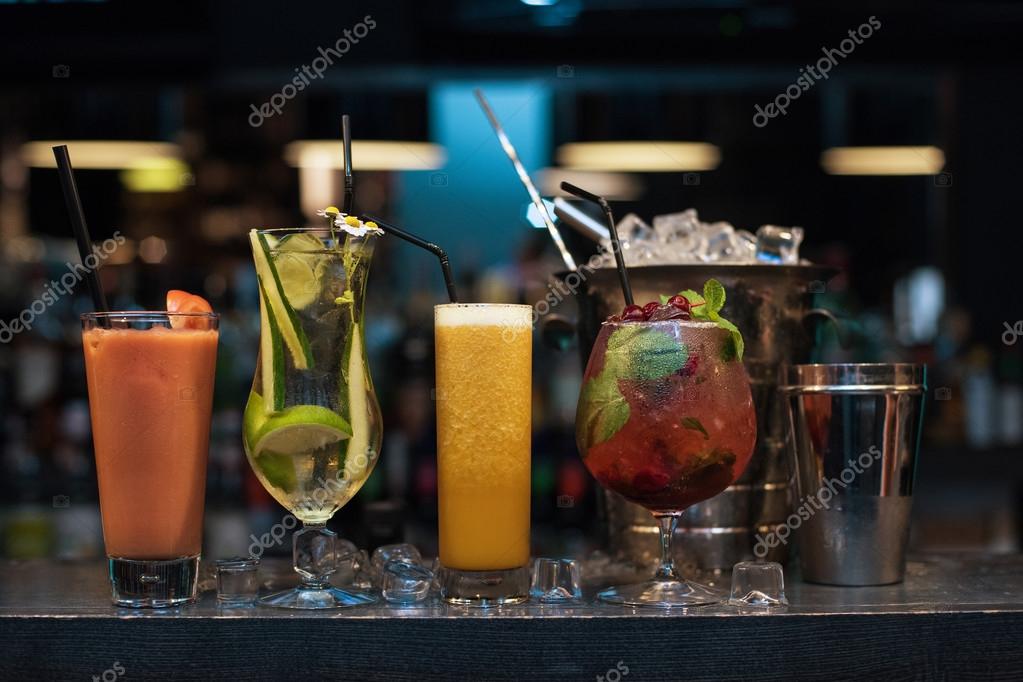 Cocktails on bar background Stock Photo by ©olinchuk 117697280