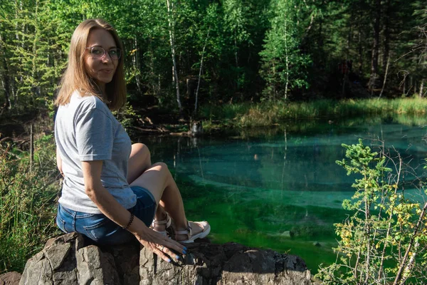 Woman resting at mountain lake in summer — Stock Photo, Image