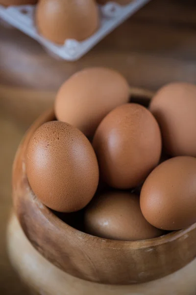 Fresh eggs at wooden plate — Stock Photo, Image