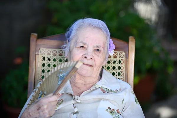 Grandma with hand fan — Stock Photo, Image