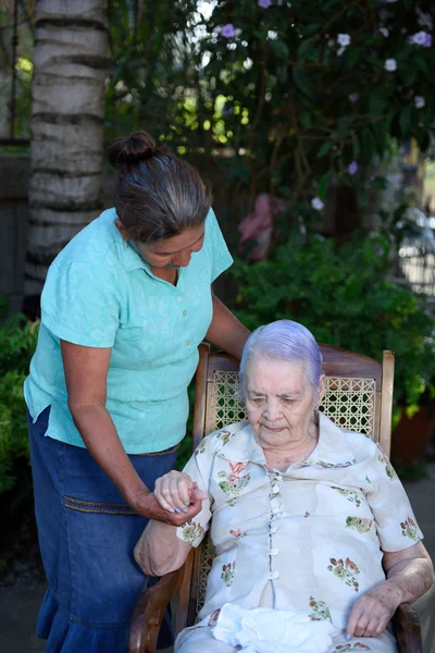 Жінка допомагає старій леді — стокове фото