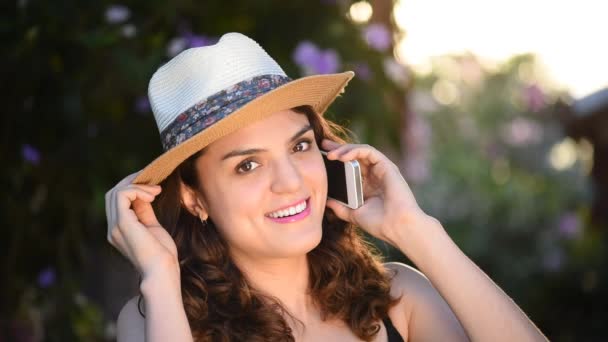 Girl in hat talk on smartphone — Stock Video