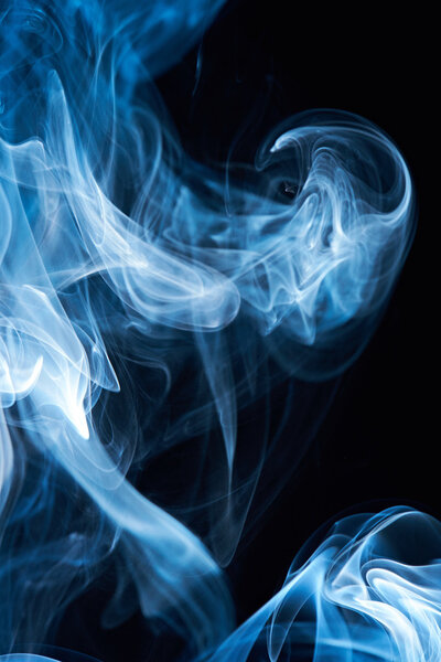 Abstract blue smoke isolated on black background