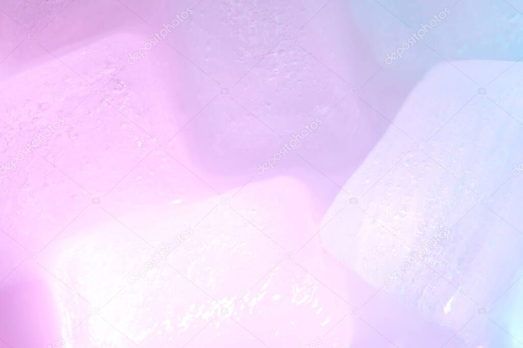 Pink color illuminated ice background macro close up view