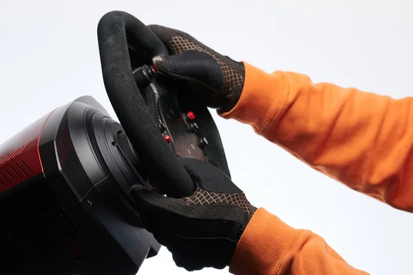 Holding sport wheel in gloves and driving side view isolated