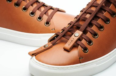 Kahverengi spor ayakkabılarının bağcıkları ön tarafta. Yakın çekim.