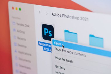 New york, USA - April 19, 2021: Click and open adobe photoshop app on laptop screen macro close up view