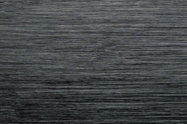 Brushed black metal background texture macro close up view