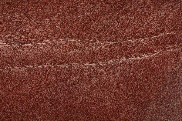 Real brown leather surface with wrinkles macro close up view
