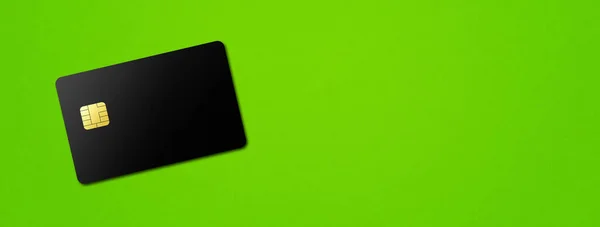 Black credit card template on a green background banner. 3D illustration