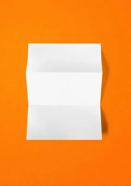 Blanco Gevouwen Wit Papier Vel Mockup Template Geïsoleerd Oranje Achtergrond — Stockfoto