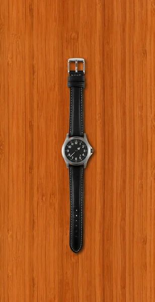 Schwarze Armbanduhr Isoliert Auf Dunklem Holzhintergrund — Stockfoto