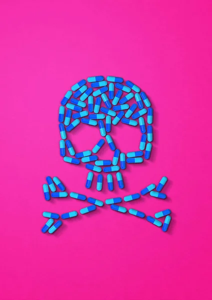 ピンクの背景に隔離された青いカプセル薬で作られた頭蓋骨 3Dイラスト — ストック写真